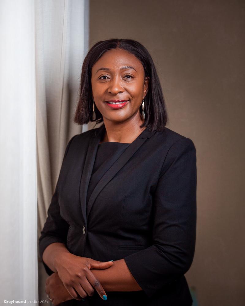 a portrait picture of a woman dressed in a black suit