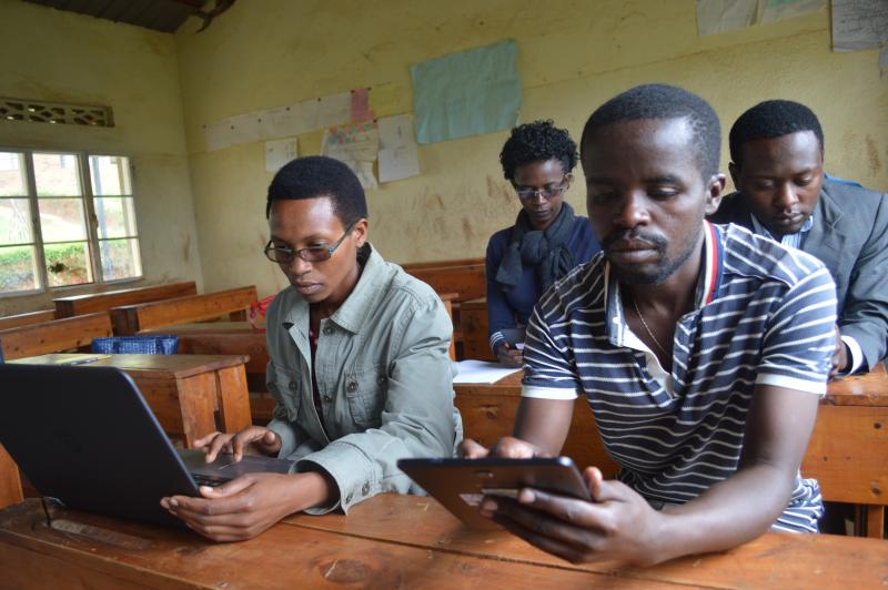 a group of students working on a computer and tablet