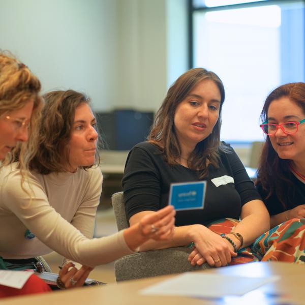 a group of women reading a card during a workshop