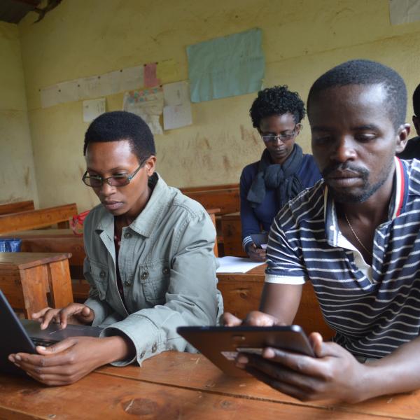 a group of students working on a computer and tablet