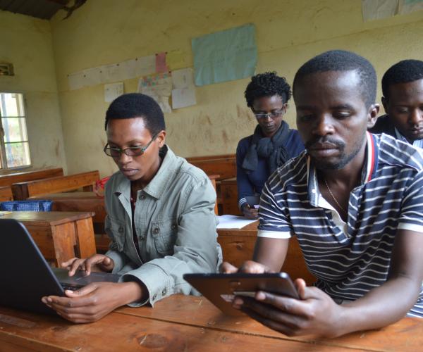 a group of students working on a computer and tablet